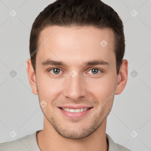 Joyful white young-adult male with short  brown hair and grey eyes