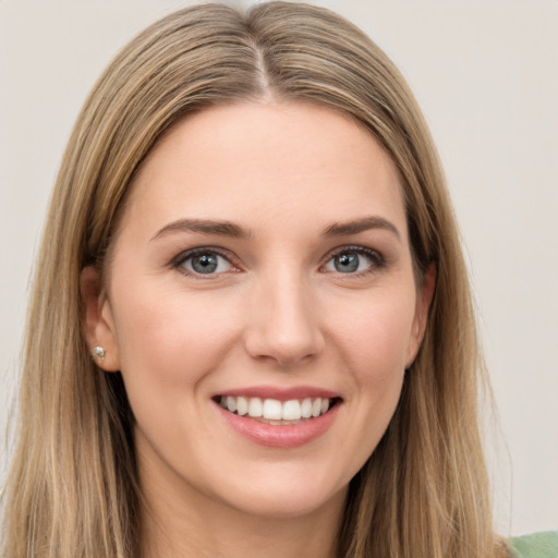 Joyful white young-adult female with long  brown hair and grey eyes