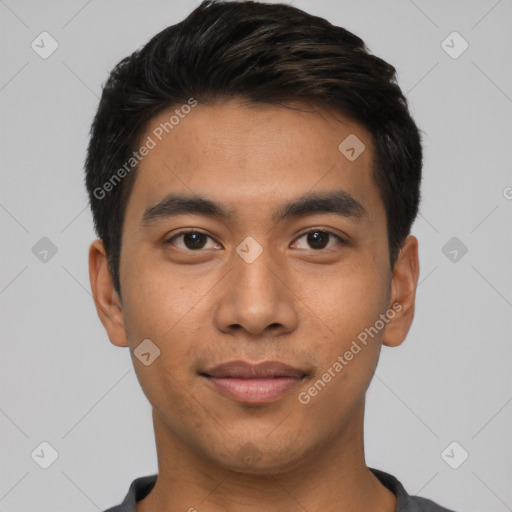 Joyful latino young-adult male with short  black hair and brown eyes