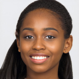 Joyful black young-adult female with long  brown hair and brown eyes