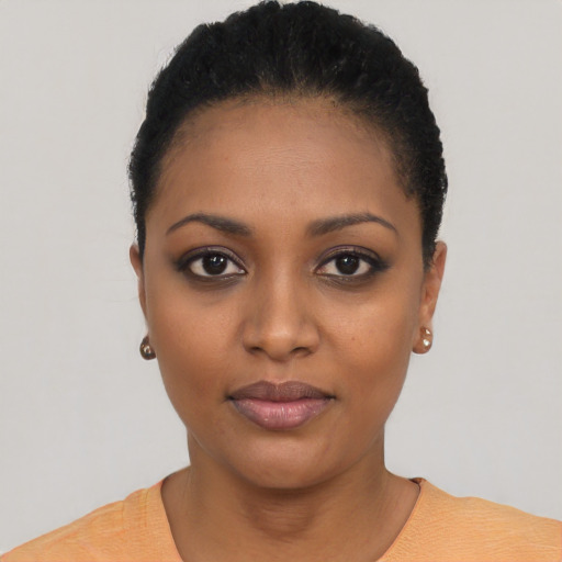 Joyful black young-adult female with short  black hair and brown eyes