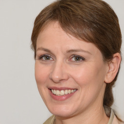 Joyful white adult female with medium  brown hair and grey eyes