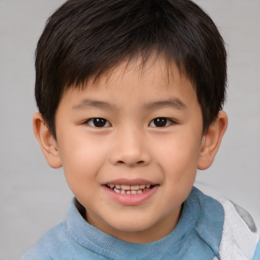 Joyful white child male with short  brown hair and brown eyes