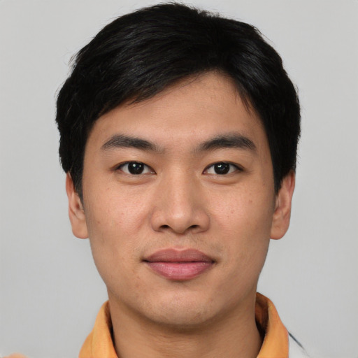 Joyful asian young-adult male with short  black hair and brown eyes