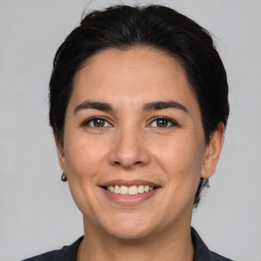 Joyful white adult female with short  brown hair and brown eyes