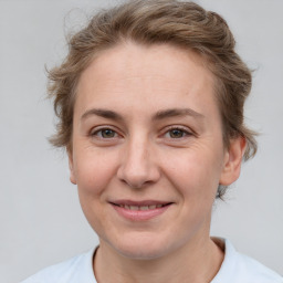 Joyful white adult female with short  brown hair and grey eyes