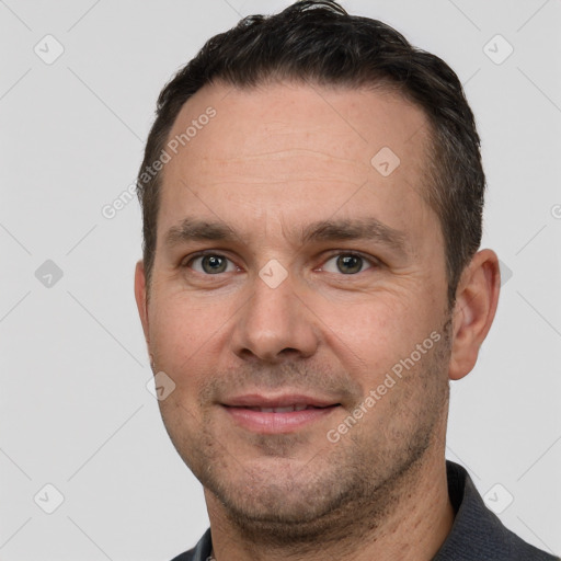 Joyful white adult male with short  brown hair and brown eyes