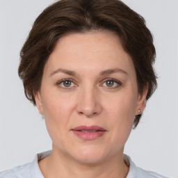 Joyful white adult female with short  brown hair and brown eyes