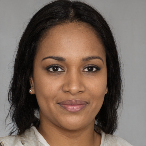 Joyful black young-adult female with medium  brown hair and brown eyes