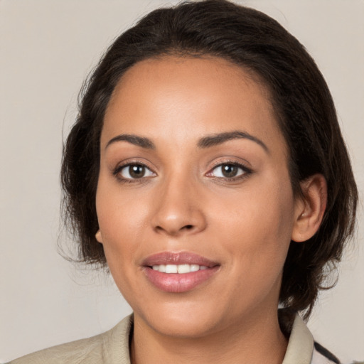 Joyful white young-adult female with medium  brown hair and brown eyes