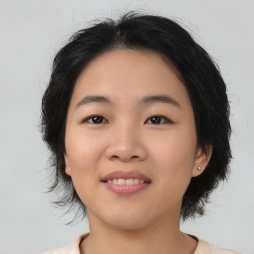 Joyful asian young-adult female with medium  black hair and brown eyes