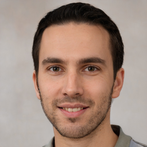 Joyful white young-adult male with short  brown hair and brown eyes