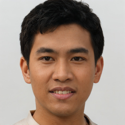 Joyful asian young-adult male with short  black hair and brown eyes