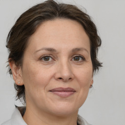 Joyful white adult female with medium  brown hair and brown eyes