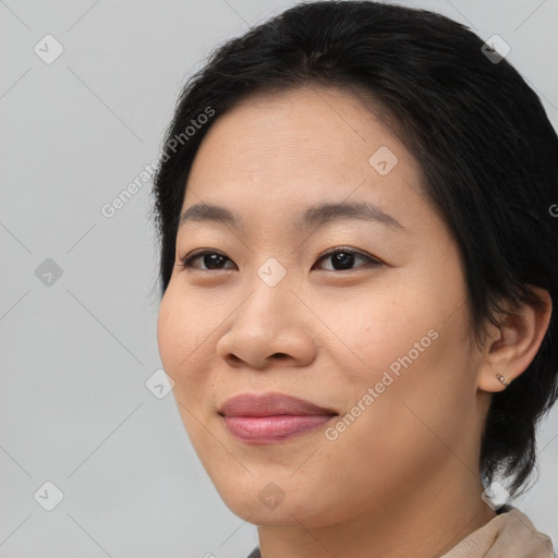 Joyful asian young-adult female with medium  brown hair and brown eyes