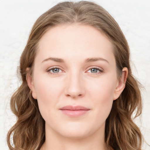 Joyful white young-adult female with long  brown hair and blue eyes