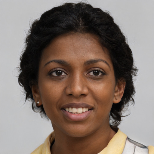 Joyful black young-adult female with medium  brown hair and brown eyes