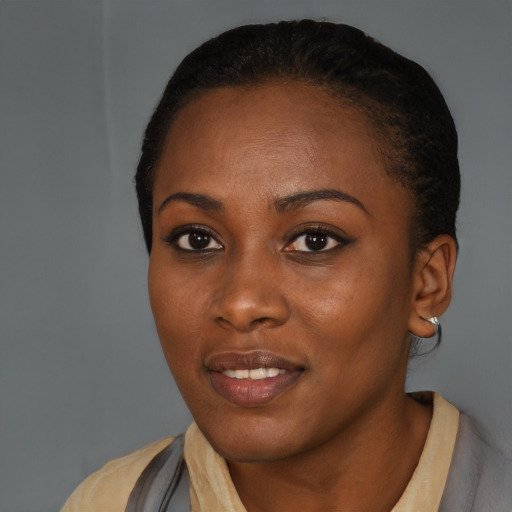 Joyful black young-adult female with short  black hair and brown eyes