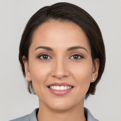 Joyful white young-adult female with medium  brown hair and brown eyes