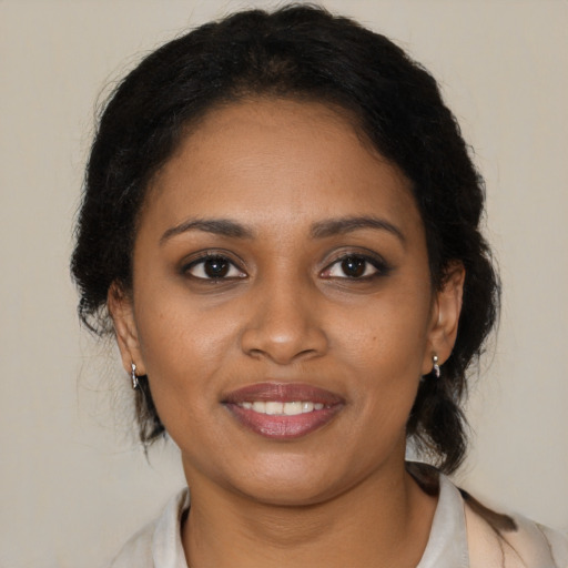 Joyful black young-adult female with medium  brown hair and brown eyes