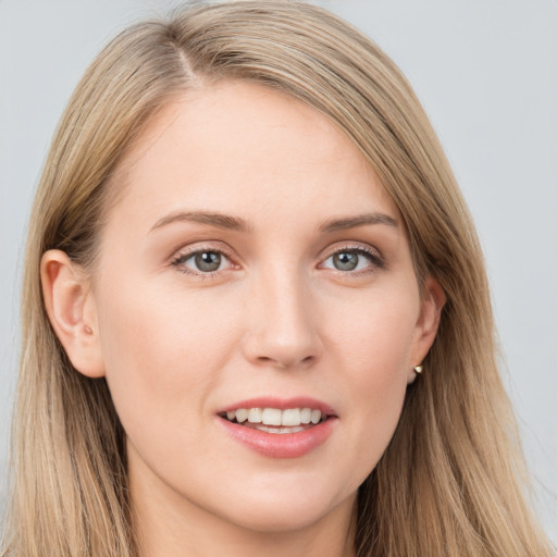 Joyful white young-adult female with long  brown hair and grey eyes