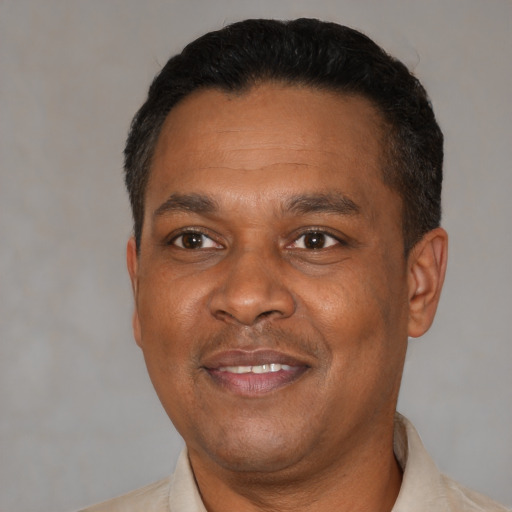Joyful latino adult male with short  black hair and brown eyes