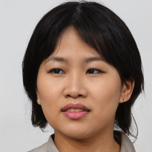Joyful asian young-adult female with medium  black hair and brown eyes