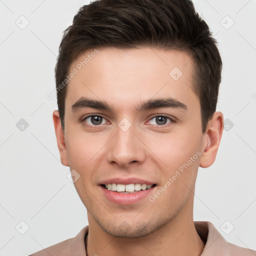 Joyful white young-adult male with short  brown hair and brown eyes