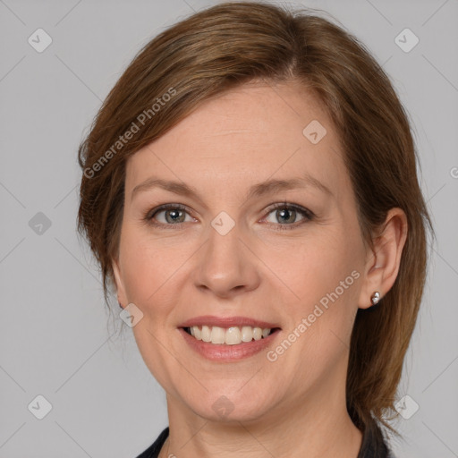 Joyful white adult female with medium  brown hair and grey eyes