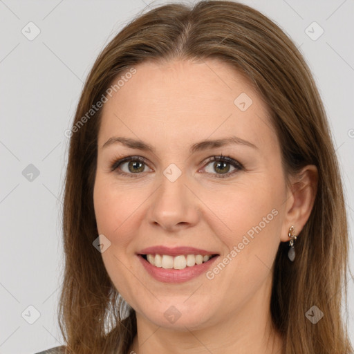 Joyful white adult female with long  brown hair and brown eyes