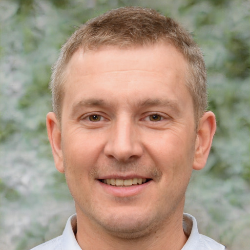 Joyful white adult male with short  brown hair and brown eyes