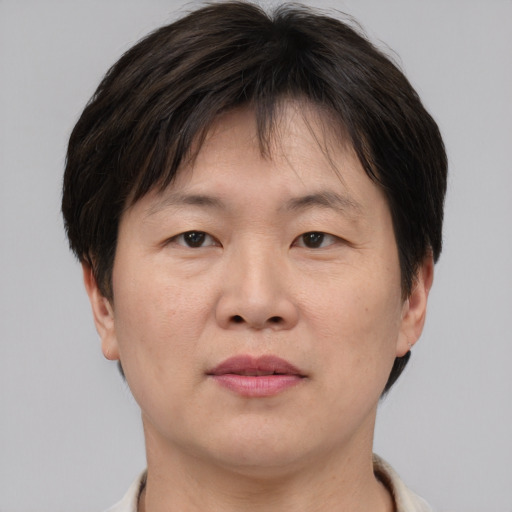 Joyful asian adult male with short  brown hair and brown eyes