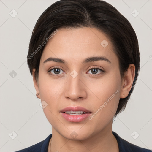 Joyful white young-adult female with short  brown hair and brown eyes