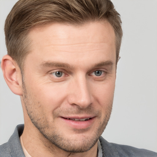 Joyful white adult male with short  brown hair and grey eyes