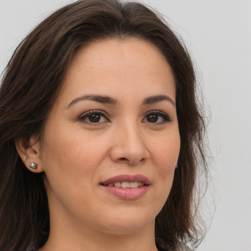 Joyful white young-adult female with long  brown hair and brown eyes