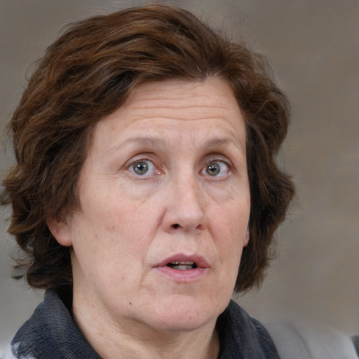 Neutral white middle-aged female with medium  brown hair and blue eyes