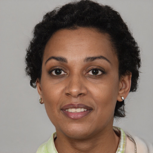 Joyful black adult female with short  brown hair and brown eyes