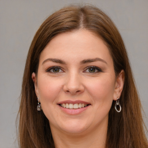 Joyful white young-adult female with long  brown hair and grey eyes