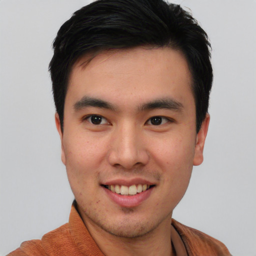 Joyful asian young-adult male with short  black hair and brown eyes