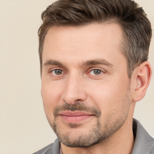 Joyful white adult male with short  brown hair and brown eyes