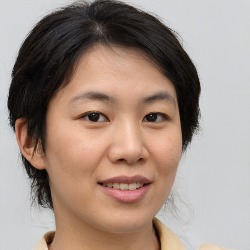 Joyful asian young-adult female with medium  brown hair and brown eyes