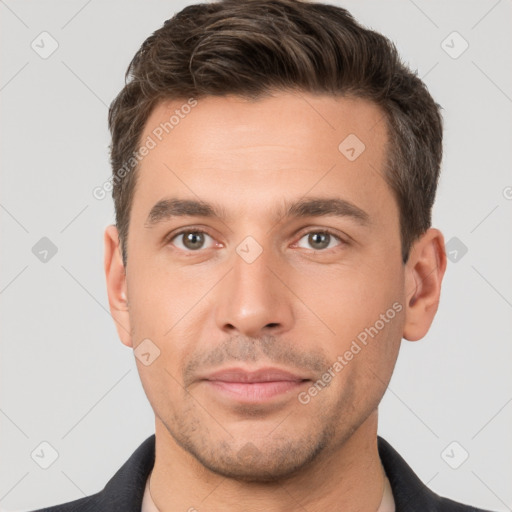 Joyful white young-adult male with short  brown hair and brown eyes