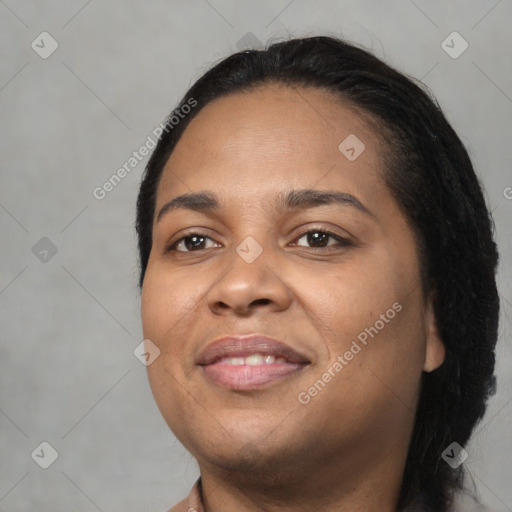 Joyful black young-adult female with long  black hair and brown eyes