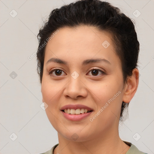 Joyful latino young-adult female with medium  brown hair and brown eyes