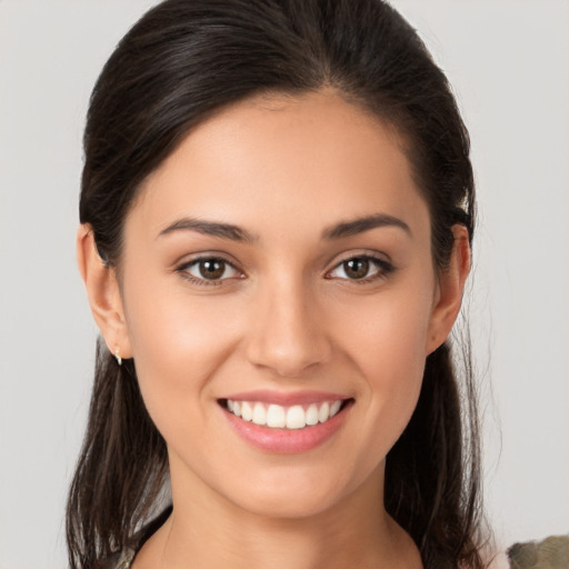 Joyful white young-adult female with long  brown hair and brown eyes