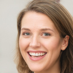 Joyful white young-adult female with long  brown hair and green eyes