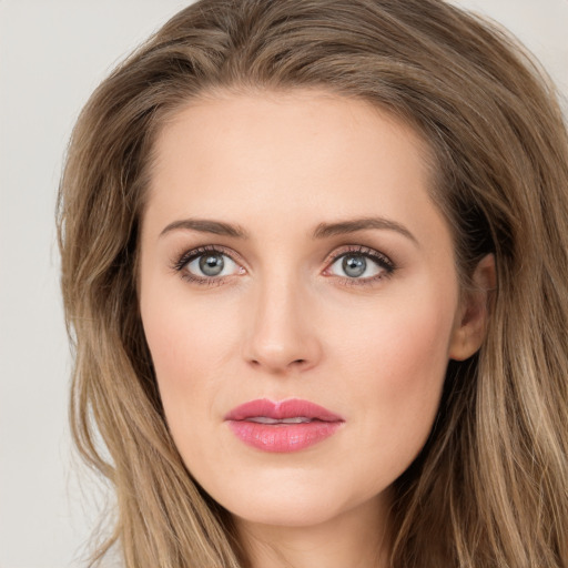 Joyful white young-adult female with long  brown hair and green eyes