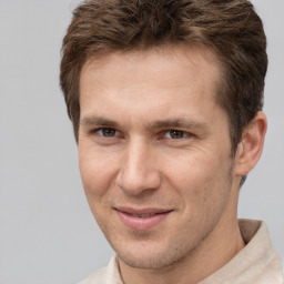 Joyful white adult male with short  brown hair and brown eyes