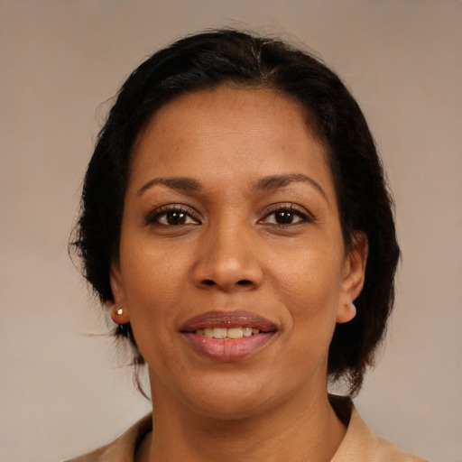 Joyful black adult female with medium  brown hair and brown eyes