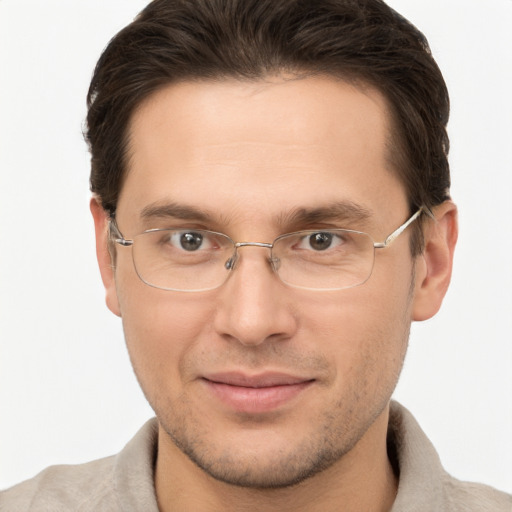 Joyful white adult male with short  brown hair and brown eyes